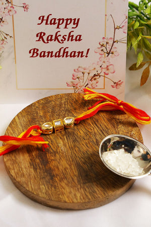 Gold Tone Kundan Rakhi With Red Yellow Cotton Thread