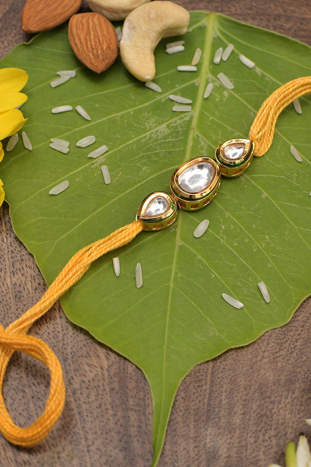 Gold Tone Kundan Rakhi With Yellow Cotton Thread